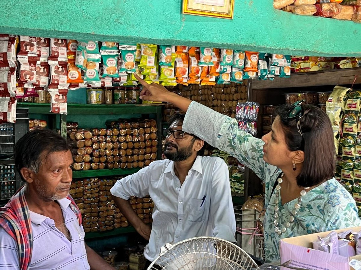 Vani on a market visit, checking shelves at a local store